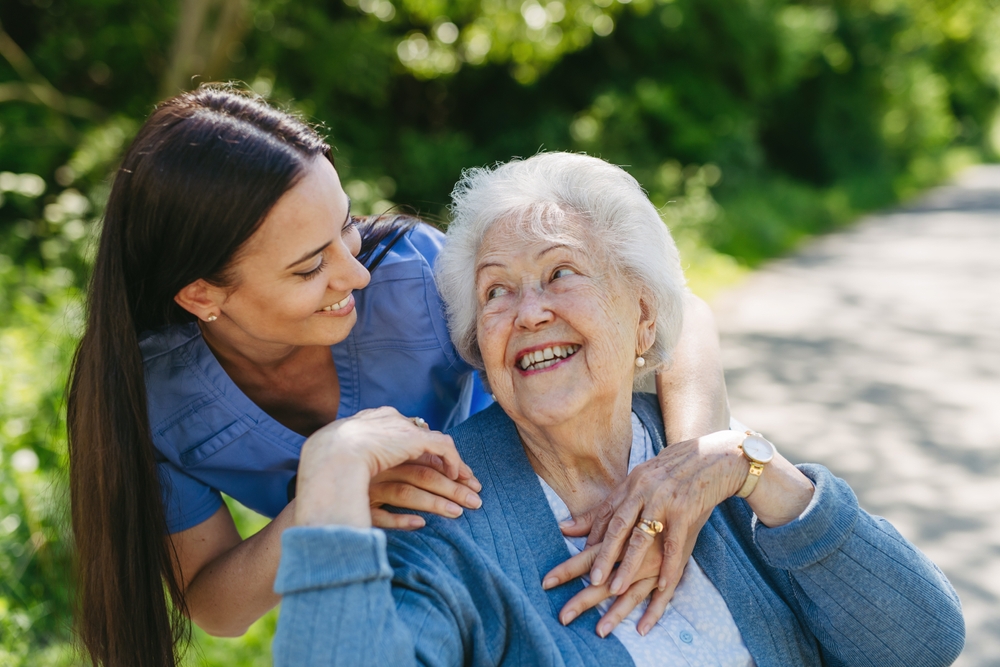 Compassionate caregiver assisting senior at home